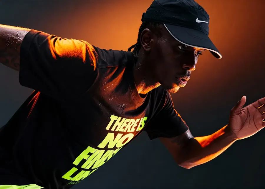 A runner in a Nike cap lit in orange at night
