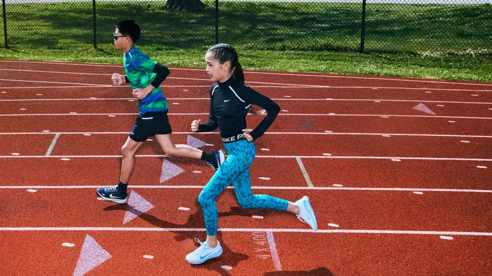 Two kids sprinting on the running track